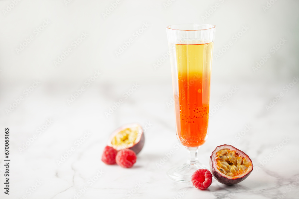 Fresh sparkling berry drink with passion fruits and raspberries in wine glass. Fresh sparkling berry drink with passion fruits and raspberries in wine glass.