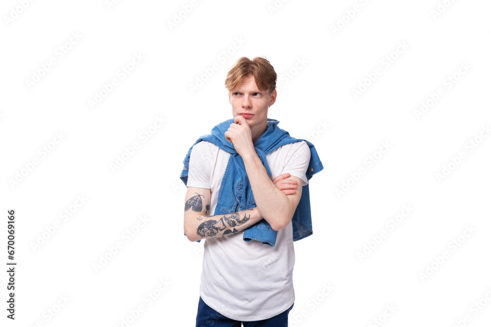young successful red-haired guy in a blue shirt is brainstorming young successful red-haired guy in a blue shirt is brainstorming