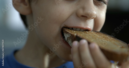 Little boy eating toast bread  close-up child mouth takes a bite of food in speed ramp