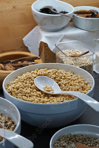 Ceramic bowls full of organic barley cereal whole grain, nuts, oats and seeds © chettarin