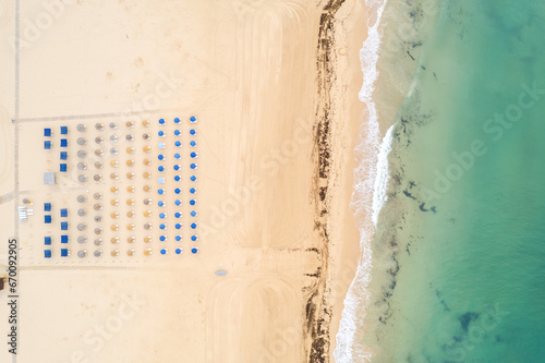 Aerial drone view of  sandy beach of Praia da Rocha and Atlantic Ocean waves, Algarve,Portugal