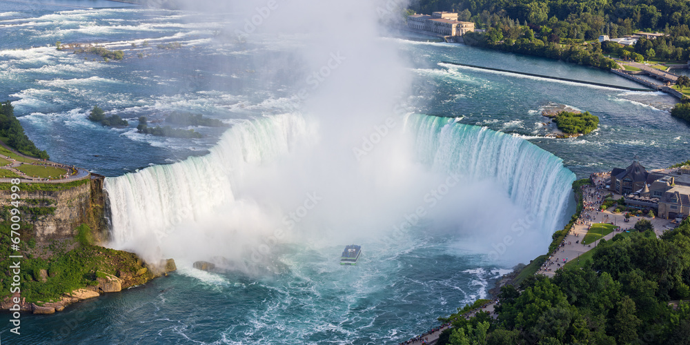 High angle, close-up view of the Horseshoe falls in Niagara Falls, Canada, while tourist boat is nearing the falls