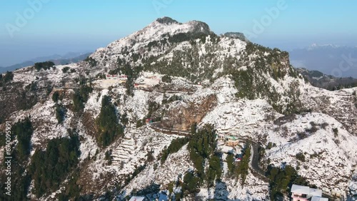 Aerial view of beautiful snow-covered mountains during winters in the Himalayan region of Uttarakhand. First Snowfall in Dhanaulti, India. Hill station covered in snow. Foothills of Himalayas. photo