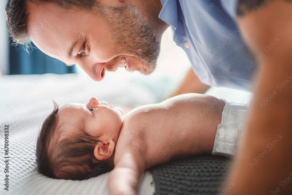 father on bedroom with his newborn baby son - obrazy, fototapety, plakaty 