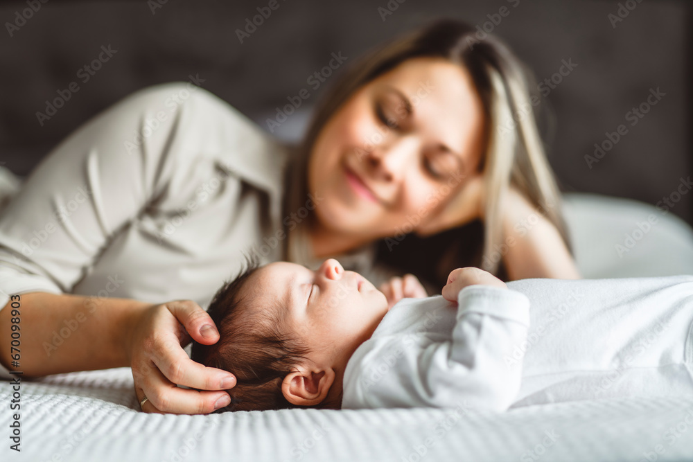 Mother on bedroom with his newborn baby son Mother on bedroom with his newborn baby son