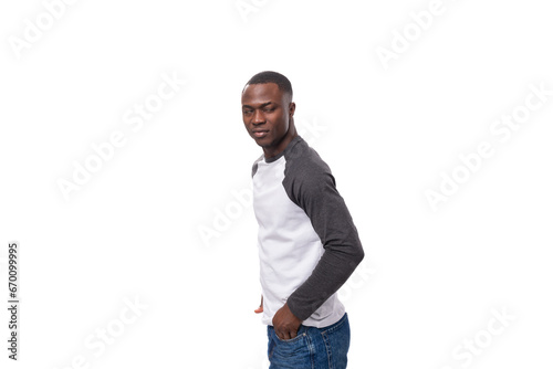 close-up portrait of a young handsome american guy with a short haircut in a sweatshirt on a white background with copy space