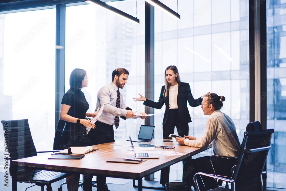 Full length view of business people collaborating around table Full length view of business people collaborating around table