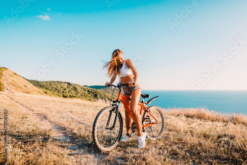 Sporty attractive woman with mountain bicycle in outdoor. Lifestyle with young lady.