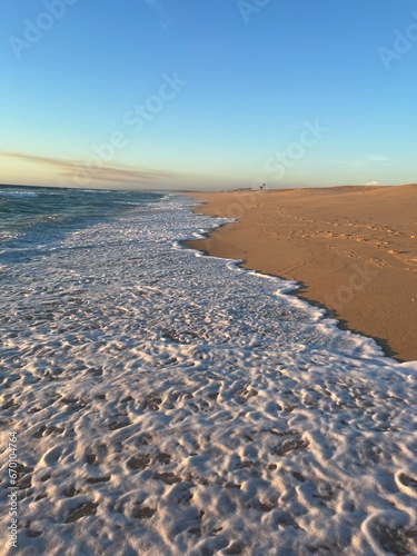 Orange sea horizon  sandy coastline  evening seascape reflection  pastel colors