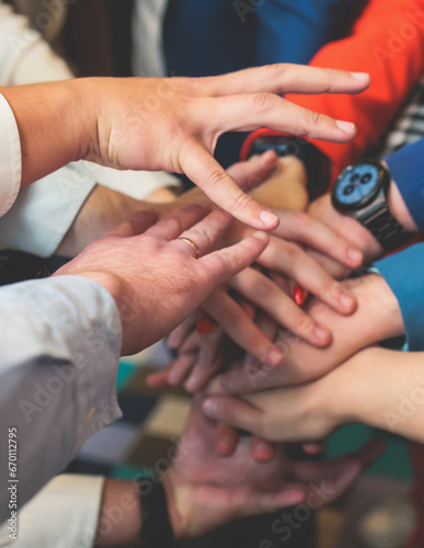 Group team of young people stacking hands together during contest competition  corporate business teamwork and support  coworkers and colleagues  team members hands of partners stacked for success
