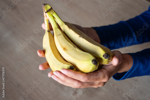 The woman holds food in her hand. the girl holds in her hands