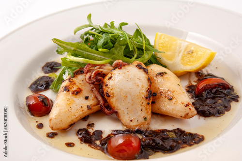 grilled whole squid with salad and tomatos