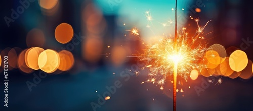A close-up of a Bengal light on a urban blurred background. Celebration of the new year and Christmas. Party accessory photo