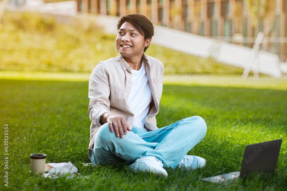 Cheerful asian man student using laptop and learning online Cheerful asian man student using laptop and learning online