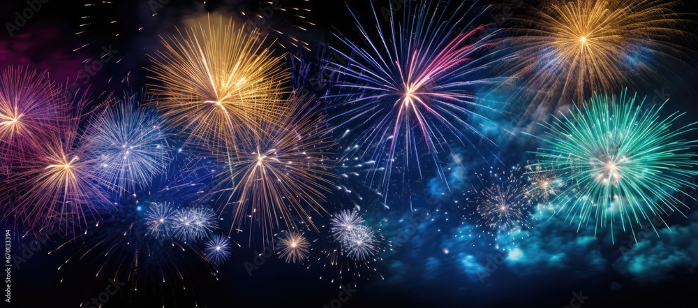 Multicolored fireworks on a dark background. Banner for the site. Place for text. Wallpaper for holidays. Festive light