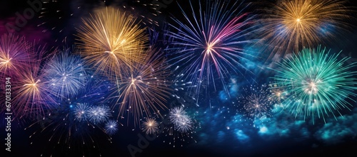 Multicolored fireworks on a dark background. Banner for the site. Place for text. Wallpaper for holidays. Festive light © masyastadnikova