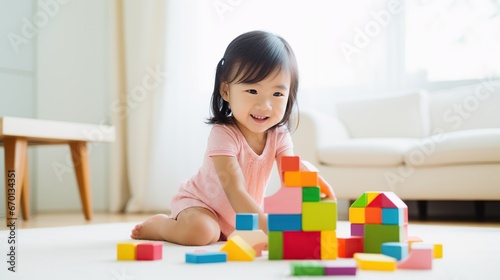  Little toddler boy playing with educational wooden toy at home