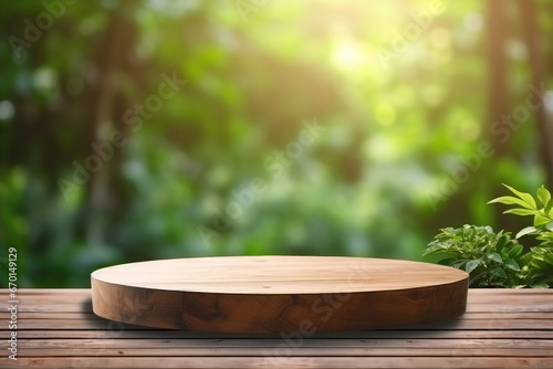 Circular wooden empty podium for presentation or advertising. Natural green blurred background with green leaves