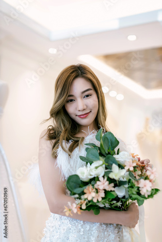 Beautiful bride with wedding flowers bouquet. Portrait of bride with bouquet. Beautiful bride and wedding bouquet.