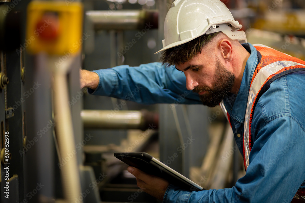 Young male engineer in metal sheet factory Responsible work is being inspected at the actual work site Young male engineer in metal sheet factory Responsible work is being inspected at the actual work site