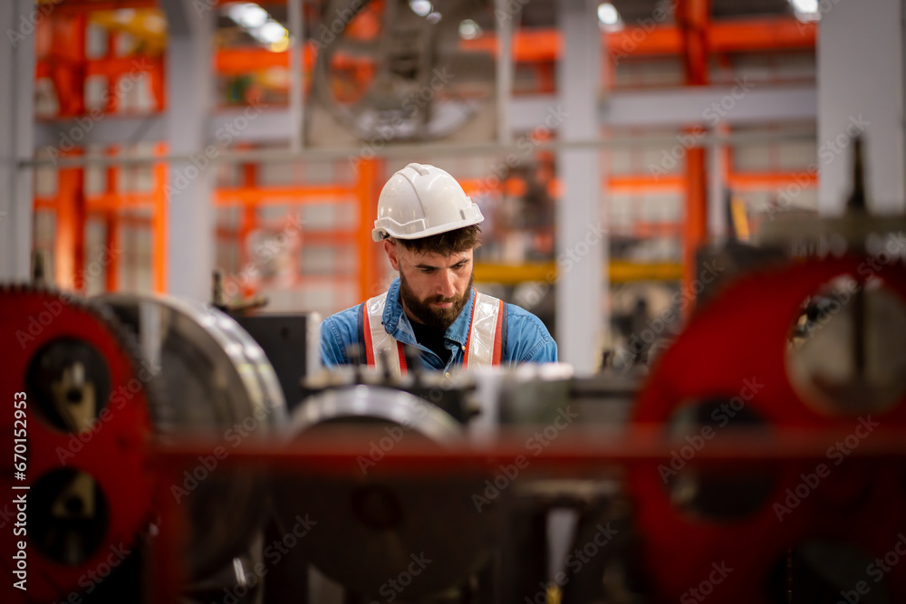 Young male engineer in metal sheet factory Responsible work is being inspected at the actual work site Young male engineer in metal sheet factory Responsible work is being inspected at the actual work site