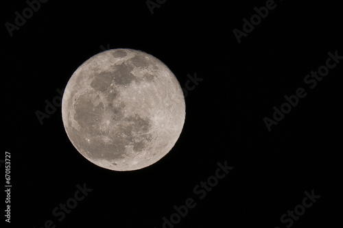 Full Moon in the night dark sky  Full Moon whit the visible surface crater in the black dark night background