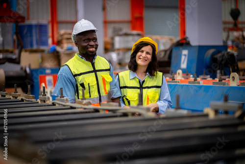 Team of young male and female engineers in a metal sheet factory Responsible work is being inspected at the actual work site.