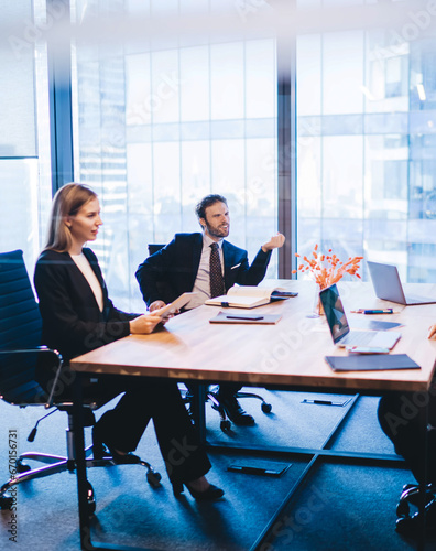 four employees communicating and discussing ideas sitting at table