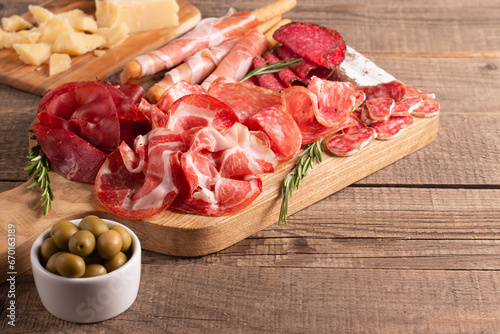 Charcuterie board. Antipasti appetizers of meat platter with salami, prosciutto crudo or jamon and olives