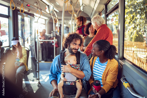 Happy multiethnic family traveling by public bus photo