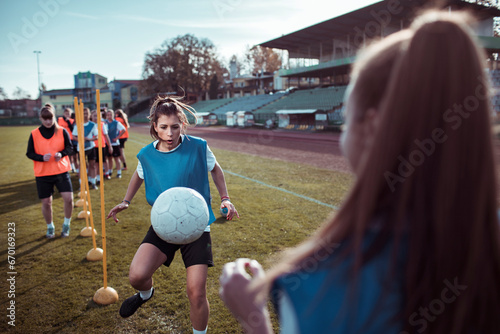 Determined female football player in action during training photo