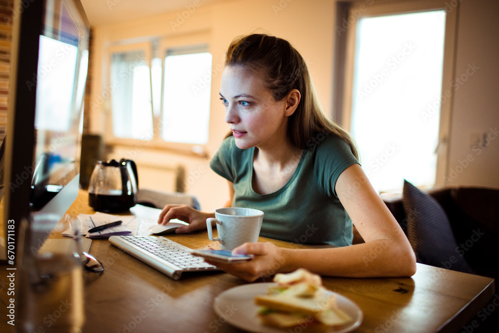 Woman working diligently from her home office Woman working diligently from her home office