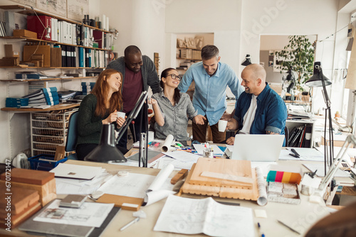 Bilde på lerret Diverse team of architects collaborating with enthusiasm in a studio