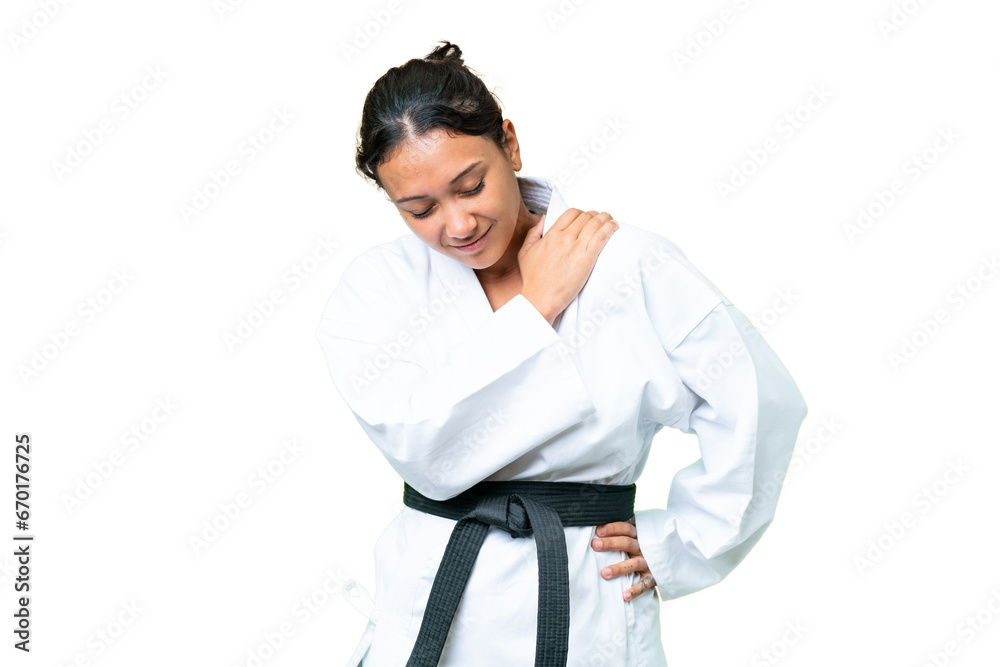 Young Uruguayan woman doing karate over isolated chroma key background suffering from pain in shoulder for having made an effort Young Uruguayan woman doing karate over isolated chroma key background suffering from pain in shoulder for having made an effort