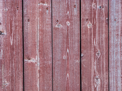 Old plank wooden wall made of boards. Old wooden boards with red nails with peeling paint abstract texture background.