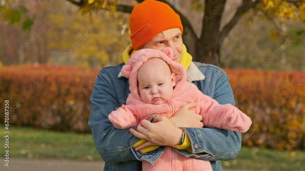 Cute baby daughter with her father in autumn park. Happy family. Cute baby daughter with her father in autumn park. Happy family.