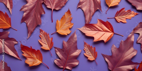 Pattern of dry orange metallic leaves on violet background. 