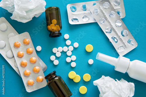 Assorted pharmaceutical medicine pills Treatment with traditional pharmaceuticals, scattered pills on a blue background