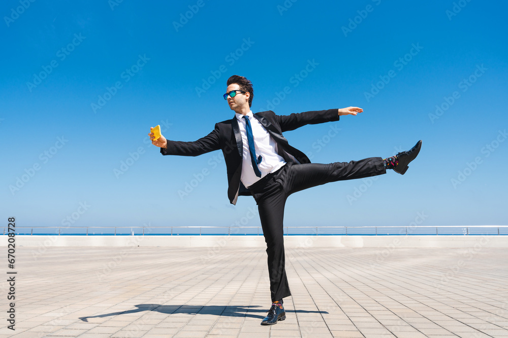 Flexible and cool businessman doing acrobatic trick Flexible and cool businessman doing acrobatic trick