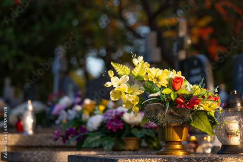 Flowers on grave. Graveyard in Poland. All saint's day.