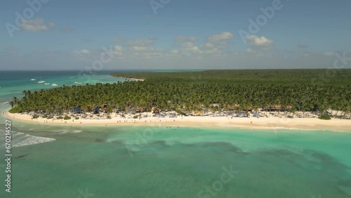 Caribbean White Sand Beach on a Tropical Isla Saona Island with Palm trees and Blue Water (Aerial Drone View in 4k)