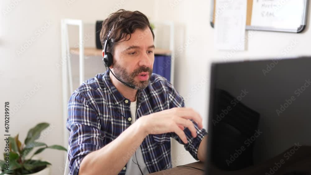 Closeup of a call center sales representative talking to a customer while sitting in front of a computer in an office
