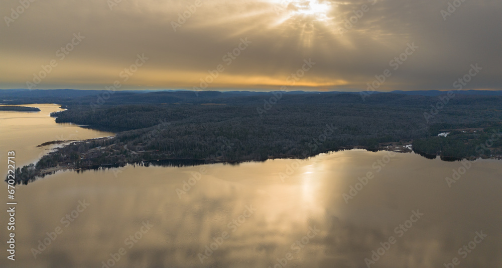Aerial view of a sunset on the Canadian countryside over a wild lake