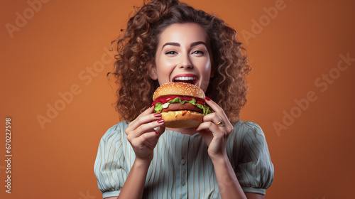 woman eating a burger laughing 