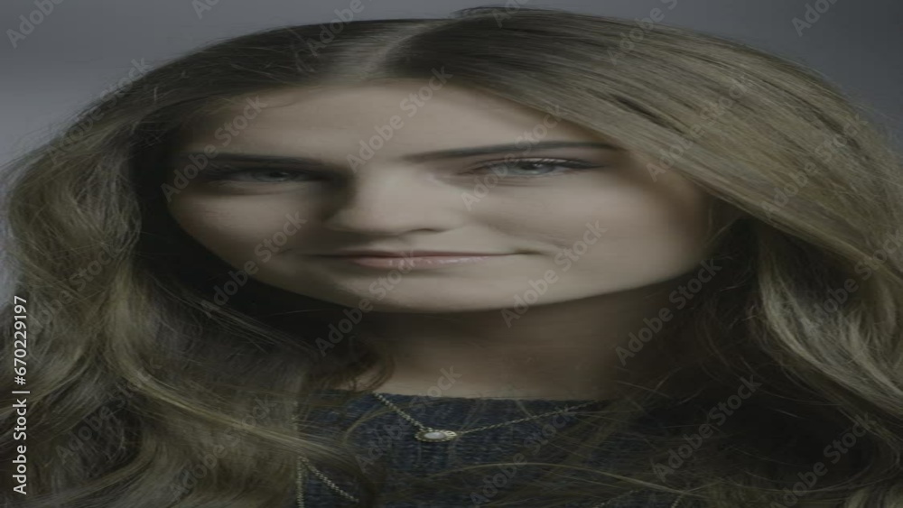 Close up portrait of wind blowing hair of smiling brunette woman in studio - vertical video / Cedar Hills, Utah, United States Close up portrait of wind blowing hair of smiling brunette woman in studio - vertical video / Cedar Hills, Utah, United States