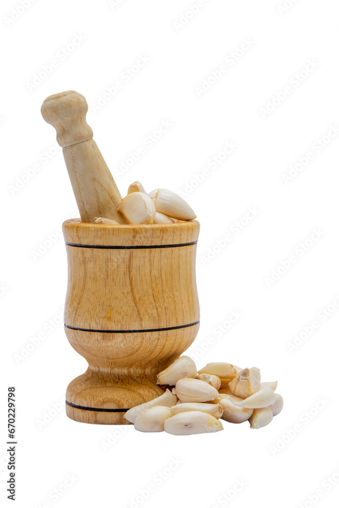 Garlic press with garlic grains on white isolated background vertical shot