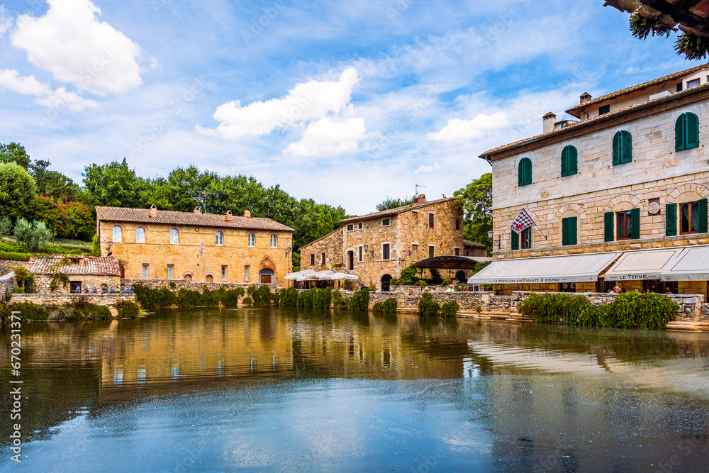 Fototapeta premium Piazza delle Sorgenti and the Old Baths in the village Bagno Vignoni, in the Val d'Orcia in Tuscany, province of Siena, Italy. Popular for its hot springs. 
