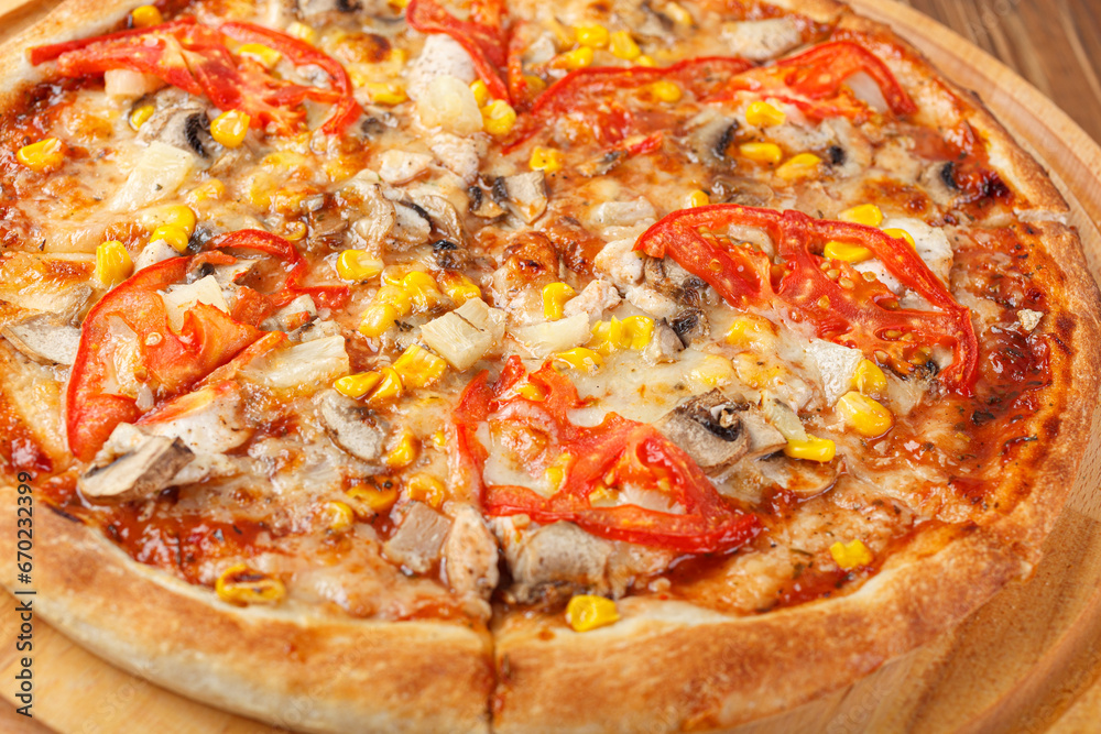 delicious pizza with chicken, mushrooms, cheese, tomatoes and corn on a wooden background delicious pizza with chicken, mushrooms, cheese, tomatoes and corn on a wooden background