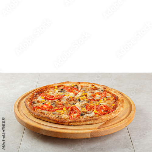 delicious pizza with chicken, mushrooms, cheese, tomatoes and corn on a concrete background