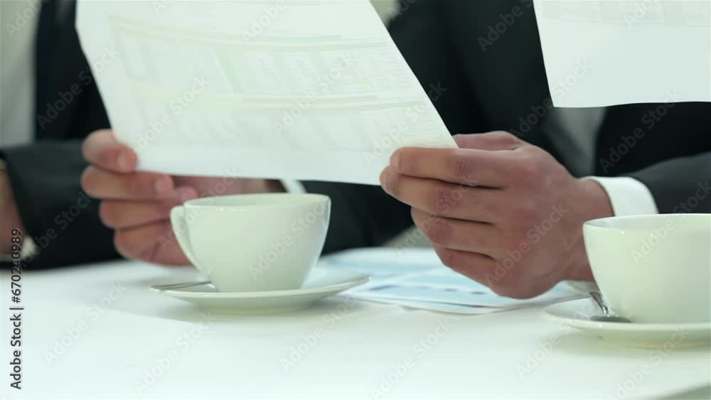 Handshake between two businessmen sitting Handshake between two businessmen sitting